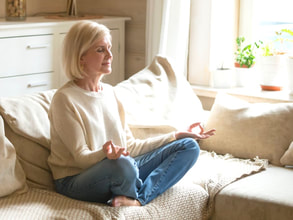 Woman Meditating on Couch